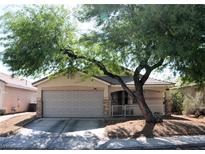 Charming single-story home featuring a two-car garage and low-maintenance desert landscaping in front at 7340 Alpine Ridge St, Las Vegas, NV 89131