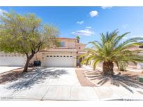 Charming two-story home with a two-car garage and mature landscaping at 7459 Aurora Glow St, Las Vegas, NV 89139