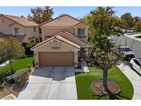 Charming two-story home featuring a well-manicured lawn and a two-car garage and concrete driveway at 9409 Kayla Ct, Las Vegas, NV 89134