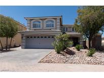 Beautiful two-story home with a landscaped yard, desert landscaping, and a spacious two-car garage at 10949 Fintry Hills St, Las Vegas, NV 89141