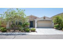 Charming single-story home with stone accents, a two-car garage, and a well-maintained landscaped front yard at 1617 Meadow Bluffs Ave, Henderson, NV 89014