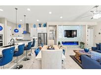 Bright, open-concept living space featuring a modern kitchen and stylish decor at 163 Caraset Ln, Henderson, NV 89011