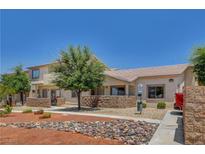 Charming home with a well-maintained front yard, mature tree, and stone accents enhancing curb appeal at 2050 N Los Feliz St # 171, Las Vegas, NV 89156
