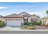 Charming single-story home featuring a well-maintained landscaped front yard and two-car garage at 2428 Hamonah Dr, Henderson, NV 89044