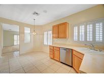 Bright kitchen features tile flooring, wooden cabinets, stainless steel appliances, and natural light at 3025 Seaford Peak Dr, Henderson, NV 89052