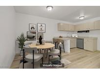 Bright dining area featuring a round table, comfortable chairs, and an adjacent kitchen with modern appliances at 304 Orland St # 47, Las Vegas, NV 89107
