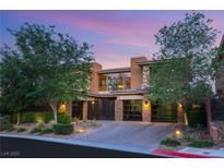Striking home showcases modern design, desert landscaping, and driveway leading to the garage at 38 Moonfire Dr, Las Vegas, NV 89135