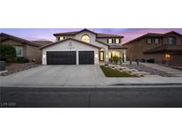 Charming two-story home with a two-car garage and desert landscaping for modern curb appeal at 387 Hoskins Ct, Henderson, NV 89012