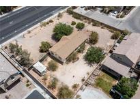 Aerial view of a single story home in a sandy lot with trees surrounded by block wall at 6337 W Cactus Ave, Las Vegas, NV 89141