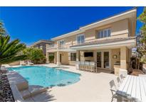 Beautiful backyard pool with an outdoor kitchen and lounging area is great for entertaining at 712 Proud Eagle Ln, Las Vegas, NV 89144