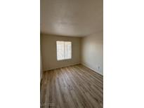 Bedroom with wood-look floors and a window at 7300 Pirates Cove Rd # 2031, Las Vegas, NV 89145
