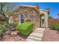 Charming single-story home featuring a stone facade and well-manicured landscaping at 776 Tillis Pl, Las Vegas, NV 89138