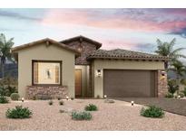 Charming single-story home featuring stone accents and desert landscaping, complete with an attached two-car garage at 82 Ibiza Lake Dr, Henderson, NV 89011