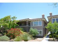 Beautiful two-story home featuring a red-tiled roof, well manicured landscaping, and lovely shrubs at 11830 Portina Dr # 2030, Las Vegas, NV 89138