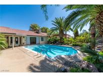 Beautiful backyard pool and patio with tropical landscaping, perfect for relaxing or entertaining at 1561 Doran Dr, Las Vegas, NV 89123