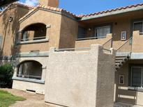 Condo exterior featuring stucco walls, red tile roofing, and outdoor stair access to the units at 220 Mission Catalina Ln # 203, Las Vegas, NV 89107