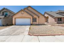 View of the home's front exterior featuring an attached garage and low maintenance landscaping at 3127 Kennewick Dr, Las Vegas, NV 89121