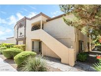 Charming condo exterior with well-maintained landscaping and a private entrance staircase at 3673 Ian Thomas St # 201, Las Vegas, NV 89129