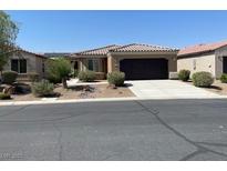 Charming single-story home with desert landscaping, a driveway and a two-car garage at 3712 Garnet Heights Ave, North Las Vegas, NV 89081