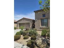 Charming stucco home with well-maintained desert landscaping and a tile roof at 4408 Oasis Plains Ave, North Las Vegas, NV 89085