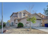Inviting two-story home featuring a well-maintained front yard and a two-car garage at 4751 Lone Grove Dr, Las Vegas, NV 89139