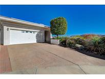 Charming home featuring a two-car garage, well-kept landscaping, and a concrete driveway at 483 Marina Cv, Boulder City, NV 89005