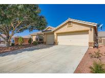Charming single-story home featuring a well-maintained yard, two-car garage and desert landscaping at 5817 Pirate Ship Dr, North Las Vegas, NV 89031
