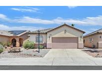 Charming single-story home with a neutral color scheme and a well-maintained front yard at 5918 Terra Grande Ave, Las Vegas, NV 89122