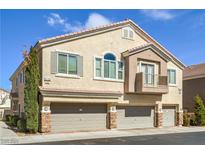 Charming townhome features multiple car garages, balcony, and a stucco exterior with a tile roof at 8798 Tom Noon Ave # 103, Las Vegas, NV 89178