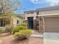 Inviting single-story home featuring desert landscaping and a charming, covered entryway at 9421 Wisdom Valley Ave, Las Vegas, NV 89149