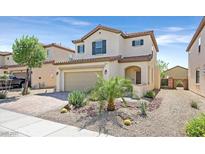 Two-story home featuring a two-car garage, desert landscaping, and a charming front porch at 953 Via Del Tramonto St, Henderson, NV 89011