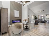 Bright, open living room with a modern fireplace and vaulted ceilings creates a cozy and inviting atmosphere at 9540 Eagle Valley Dr, Las Vegas, NV 89134