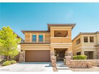 Inviting two-story home with a brown garage door and stone accents, surrounded by a well-maintained lawn at 10404 Mystic Pine Rd, Las Vegas, NV 89135
