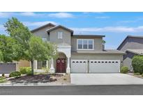 Charming two-story home with a well-manicured front yard and a two-car garage at 10673 Bonchester Hill St, Las Vegas, NV 89141