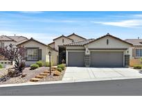Charming home features a low maintenance front yard and a two-car garage at 10701 Morning Harbor Ave, Las Vegas, NV 89129