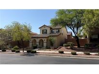 Charming two-story home with a well-manicured front yard and mature trees at 10804 Mason Hill Ave, Las Vegas, NV 89166