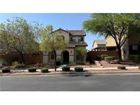 Charming two-story home with landscaped front yard and covered porch entry at 10804 Mason Hill Ave, Las Vegas, NV 89166