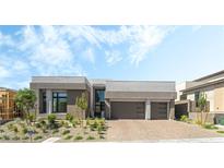 Modern home showcasing neutral colors, a front yard with new landscaping, and a brick driveway at 10919 Vista Altura Ave, Las Vegas, NV 89135