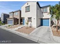 Two-story home with a two car garage and a blue entry and garage door at 1891 Via Del Prado St, Las Vegas, NV 89115