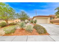 Charming single-story home with desert landscaping, a two-car garage and a long driveway at 3050 Canal Walk Rd, Henderson, NV 89052