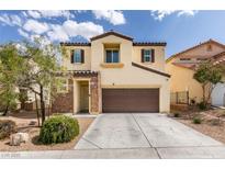 Two-story home features a two-car garage, neutral stucco, stone accents, and manicured landscaping at 5023 Salt River Ave, Las Vegas, NV 89139