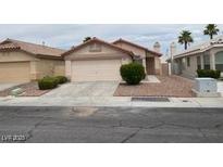 Charming single-story home with a desert-landscaped front yard, concrete driveway, and an attached two-car garage at 5824 Red Gull St, Las Vegas, NV 89149