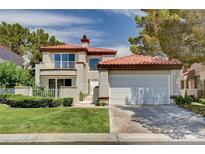 Charming two-story home featuring a red tile roof, balcony, and a well-manicured lawn at 8224 Horseshoe Bend Ln, Las Vegas, NV 89113