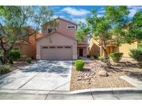Charming two-story home featuring a two-car garage and a well-maintained landscaped front yard at 9031 Jumping Jacks Ave, Las Vegas, NV 89178