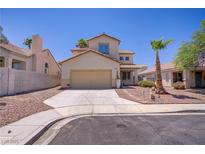 Two-story home featuring desert landscaping, attached garage, and concrete driveway at 9451 Natoma Station Pl, Las Vegas, NV 89123