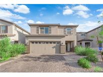 Charming two-story home with a two-car garage and brick paved driveway at 1017 Huckburn Ave, Henderson, NV 89015