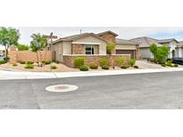 Charming single story home with stone accents, neat landscaping, and an attached two car garage at 10972 Dixie Johnson Ave, Las Vegas, NV 89166