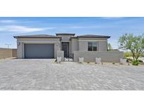 Charming single-story home featuring a paved driveway, two-car garage, and gated courtyard at 112 Springbough Ln, Las Vegas, NV 89138