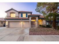 Two-story home with a tile roof, three-car garage, and manicured landscaping at 1206 Evening Canyon Ave, Henderson, NV 89014
