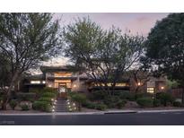 Stunning contemporary home with desert landscaping, warm lighting, and inviting staircase at 17 Soaring Bird Ct, Las Vegas, NV 89135